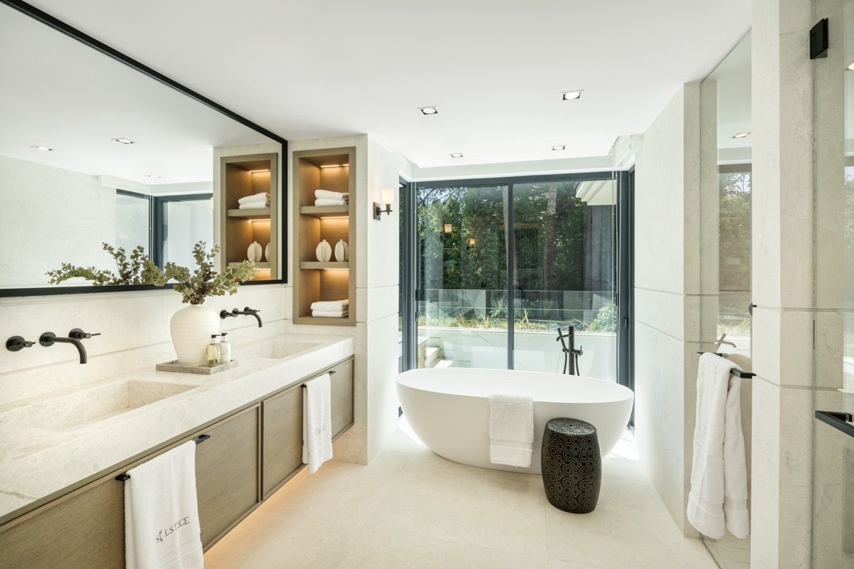 Night exterior of new-build villa with pool lighting, Puerto Banús