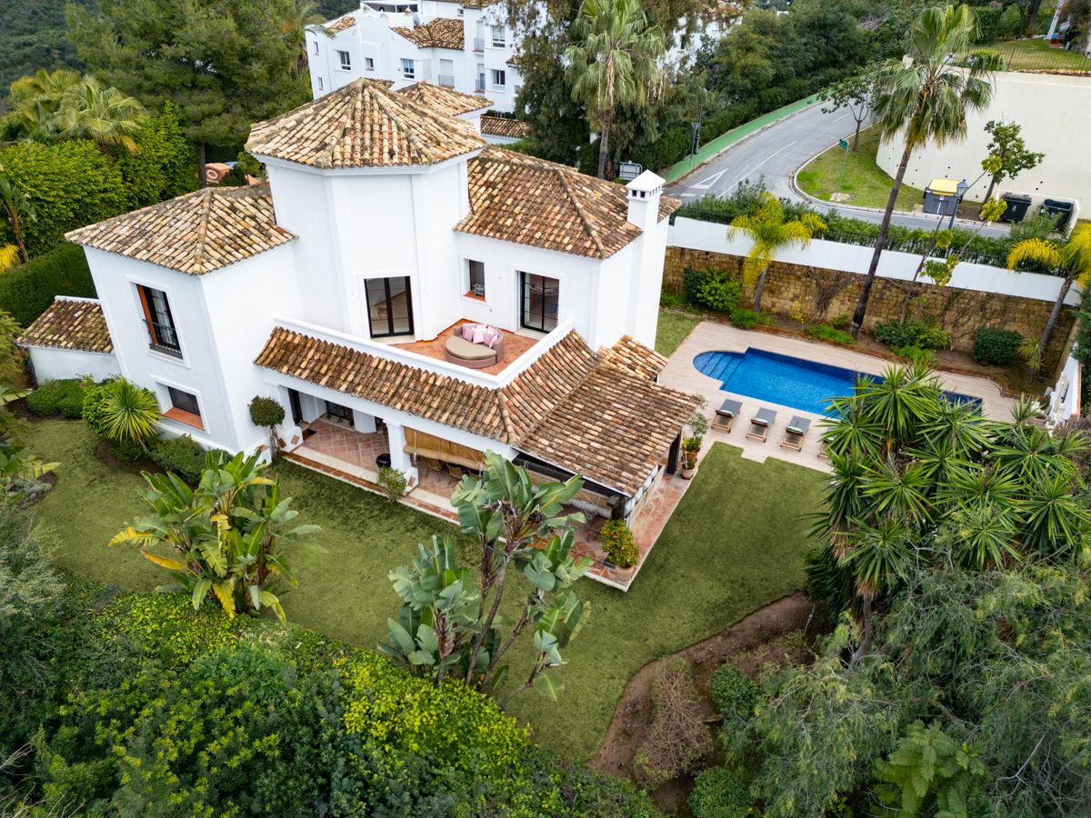 Pool and garden view from villa terrace, La Quinta, Benahavis