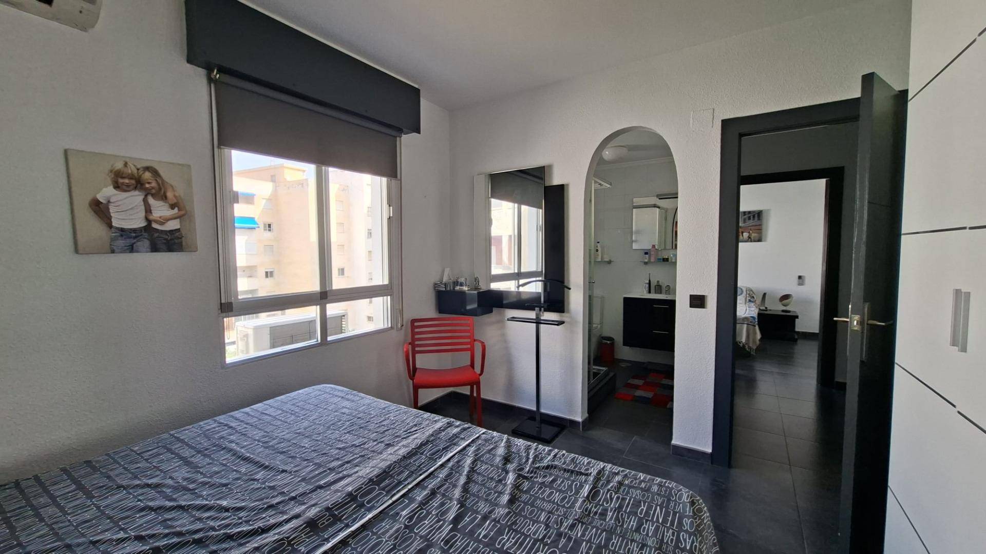 Marina and coastline viewed through living room windows in Acequion apartment