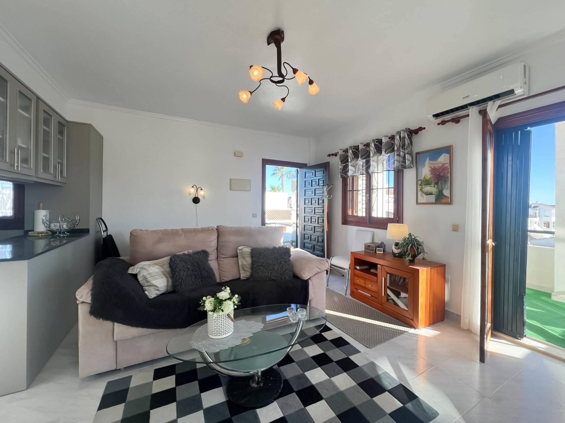 Open-plan living area with tiled flooring and large windows