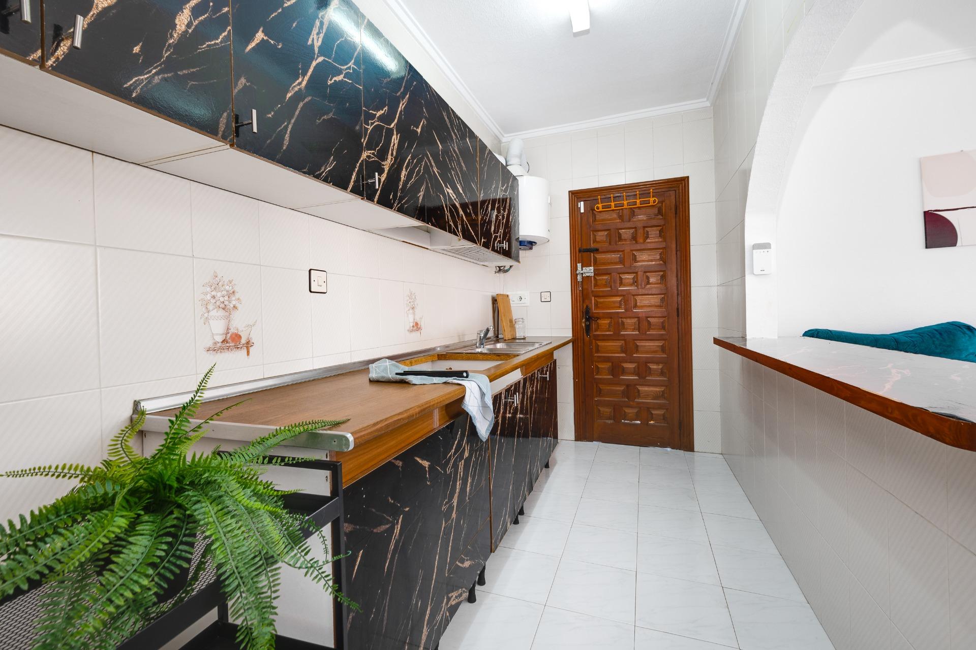 Kitchen with fitted wall units and worktop