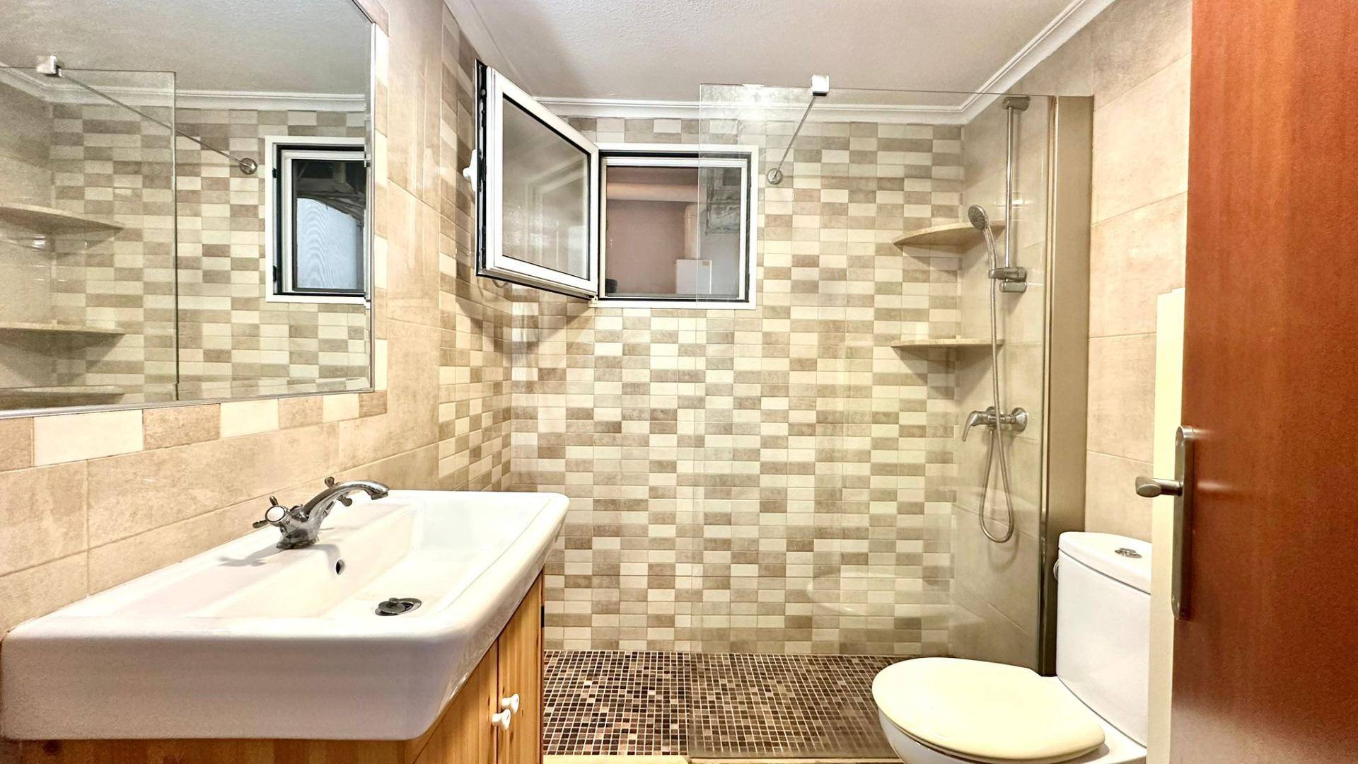 Bathroom showing tiled walls and fixtures in detail