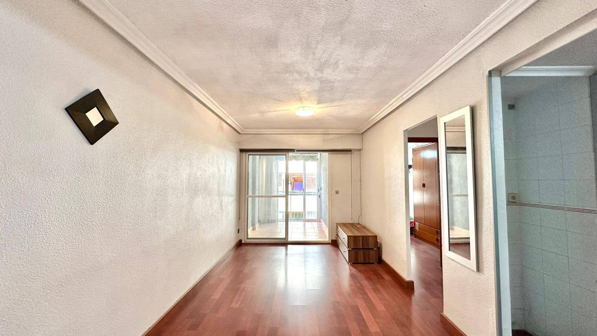 Kitchen with fitted units and window overlooking the street