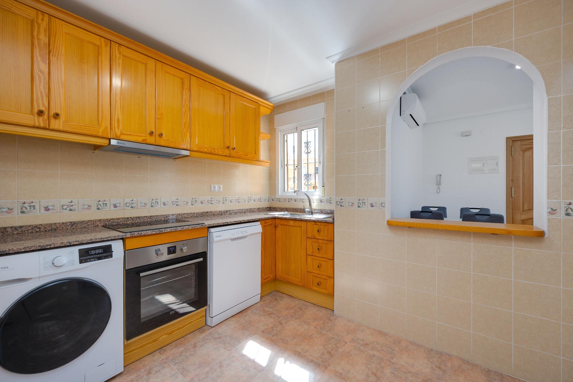 Kitchen with fitted appliances and storage units